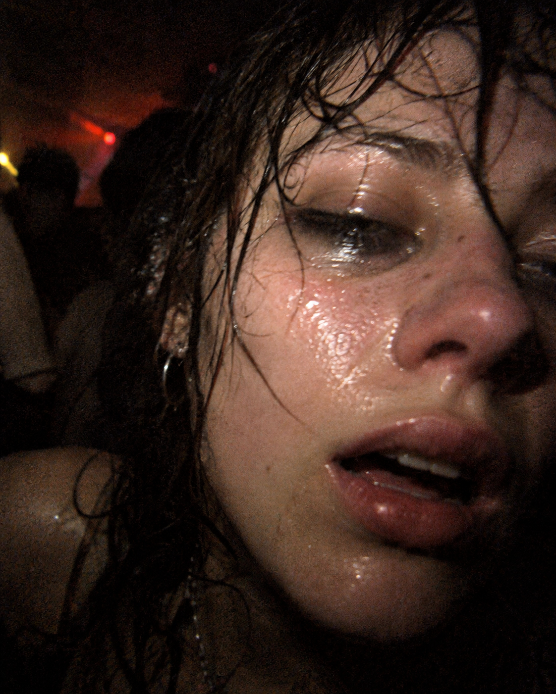 Close portrait of a sweat-covered clubgoer