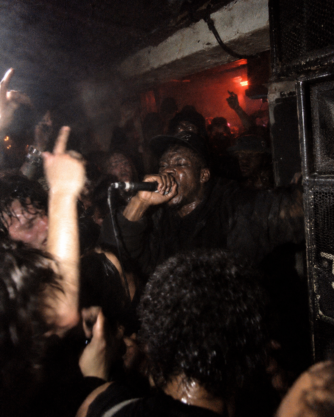 Performer with microphone surrounded by a packed crowd