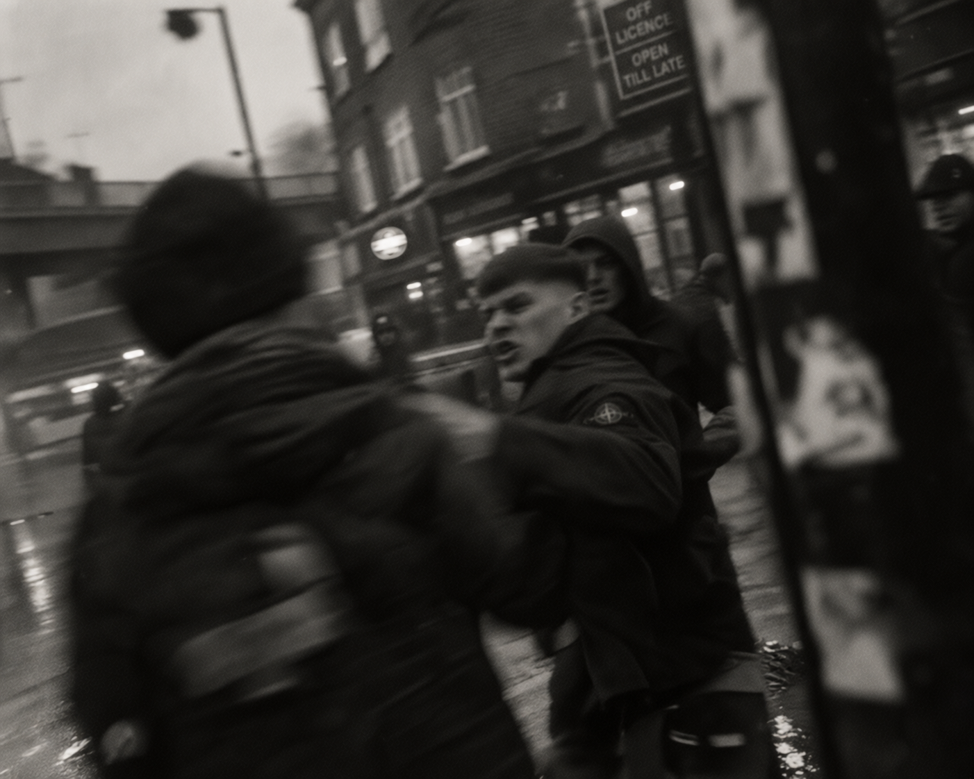 Young man in streetwear turning as tension rises on a rainy street